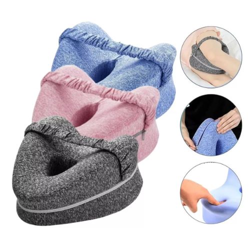 Ergonomic leg pillow with support strap designed to help keep the legs comfortably positioned while sleeping.