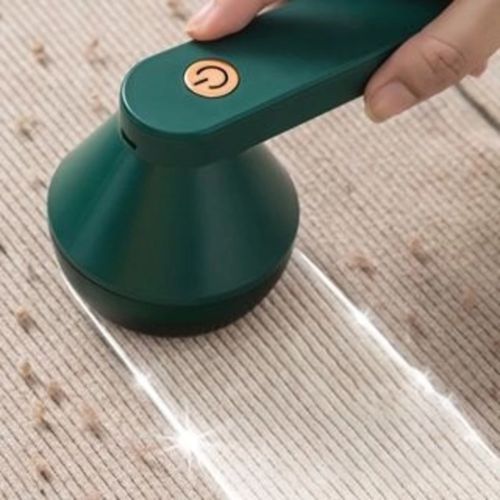 Electric fabric shaver for sweaters with a rotating blade system for convenient garment maintenance.