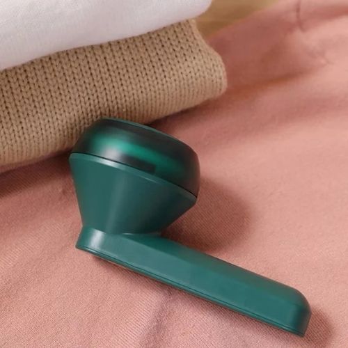 Portable electric fabric lint remover for sweaters, coats, blankets, bedding, and everyday clothing.