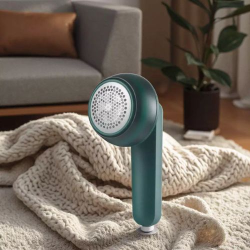 Portable fabric shaver for clothing with a compact rechargeable design for convenient fabric care.