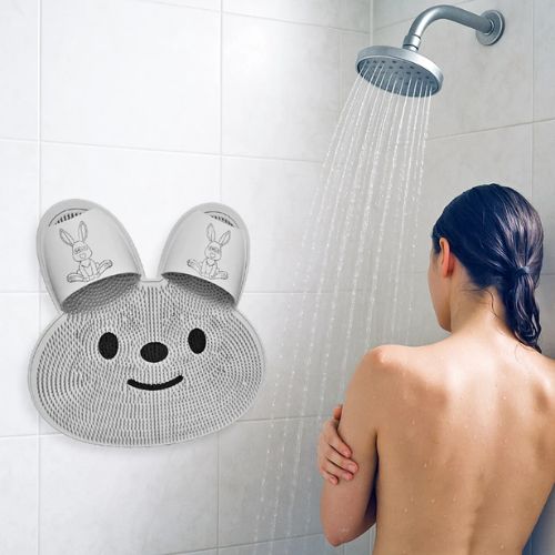 Silicone foot scrubber bath mat with soft bristles designed to clean and exfoliate the feet while showering.