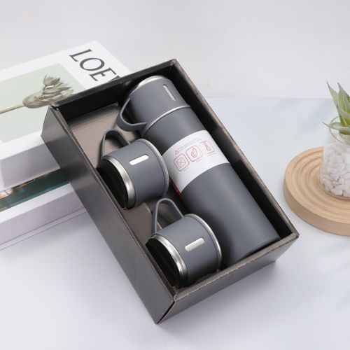 Vacuum insulated water bottle with three reusable cups for travel, hiking, camping, and everyday use.